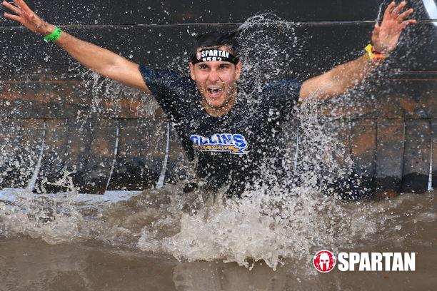 Going under the dunk wall obstacle at the Spartan Race Sprint