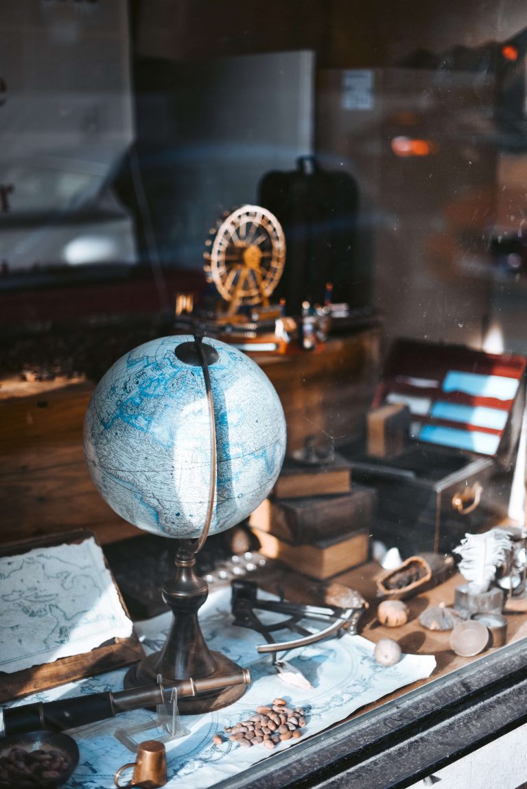 Globe on office table with many artifacts