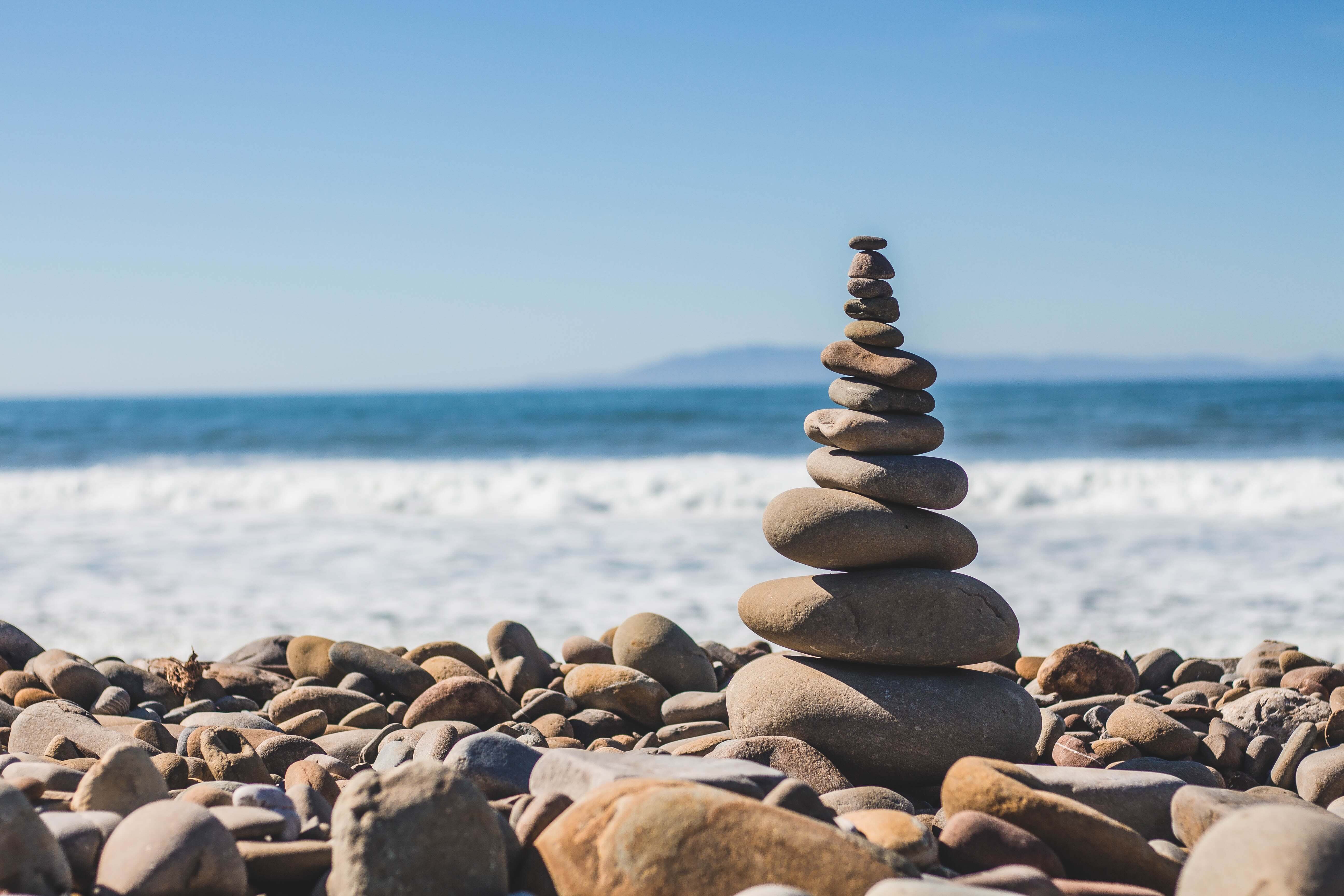 Financial Glass - Stacked Stones By the Ocean