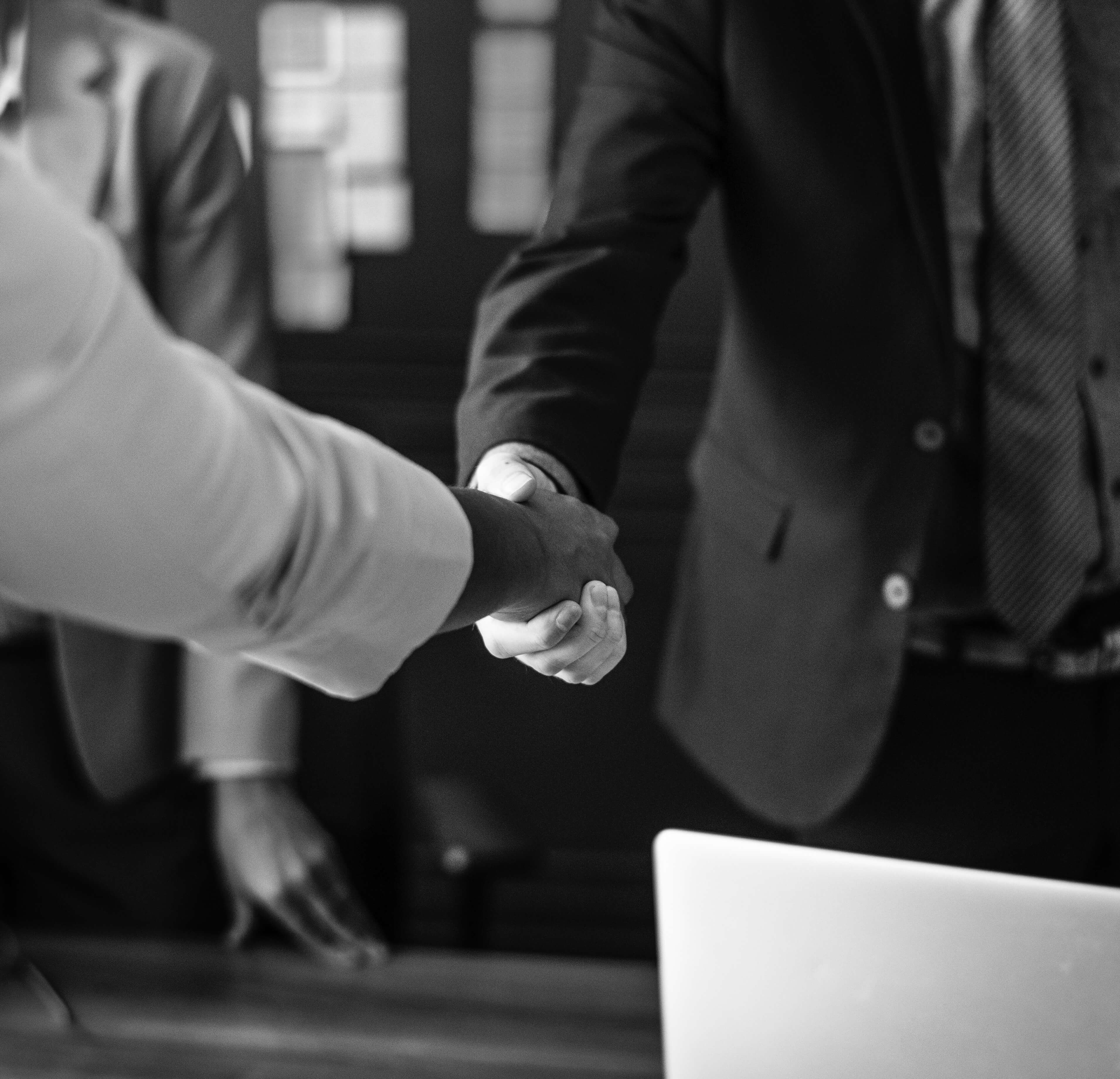 Hand shake between partners closing a deal
